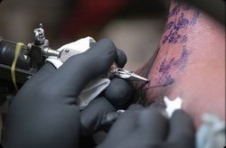 Close-up photo of person getting a tattoo.